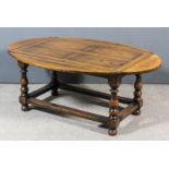 A modern oak oval drop leaf coffee table by Titchmarsh & Goodwin, with flush panelled top, on