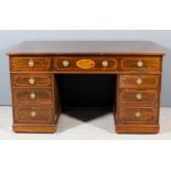 An Edwardian mahogany kneehole desk with reeded edge to top, the whole inlaid with stringings and