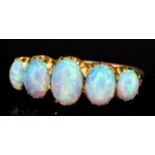 An 18ct gold mounted five stone opal ring, set with five oval stones of graduating sizes (total