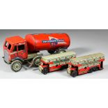 A Mettoy tinplate clockwork articulated tanker "International Oil", 8ins long, together with two