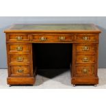 A Victorian walnut rectangular kneehole desk with green leather inset to top, fitted nine drawers,