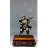 A Japanese bronze parcel-gilt okimono of an archer by Yoshimitsu, 13.5ins (34.3cm), signed in