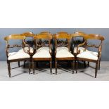 A set of eight late Georgian mahogany dining chairs (including two armchairs) with shaped crest