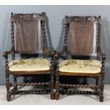 Two 17th Century walnut armchairs of "Carolean" design, the shaped crest rails carved with