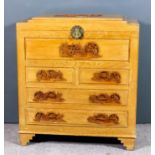 A Chinese panelled limed teak chest, the top and sides carved in relief with figures on a terrace