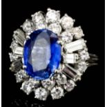 A modern 18ct white gold mounted sapphire and diamond cluster ring, set with oval cut sapphire (