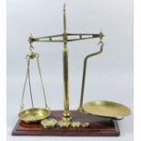 A set of brass "Class B2" balance scales by W. & T. Avery Ltd, Birmingham, on mahogany rectangular