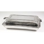 A George V silver rectangular entree dish and cover with bead mounts and angular handles, 10.5ins