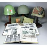 A small mixed collection of militaria, including - three helmets, compass, geometry set in canvas