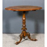 A Victorian walnut oval occasional table, the figured veneered top with shaped edge moulding, on