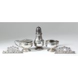 An Elizabeth II silver three-piece condiment set of circular bulbous form with spiral fluted rims,