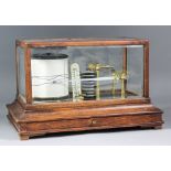 A 20th Century oak cased recording barograph in oak framed and bevelled glass case, fitted narrow