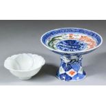 A Chinese blue and white porcelain stem cup enamelled in overglaze colours with dragons, and