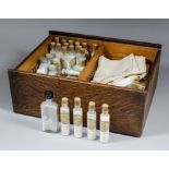 A 19th Century homeopathic pharmacy box, the interior containing a range of glass bottles with