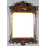 A mahogany framed rectangular wall mirror with shaped cresting and apron, the cresting painted