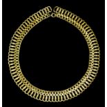 A 9ct gold double scroll link collar, 420mm overall (weight 29 grammes)