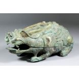 A Chinese bronze box and cover of archaic design cast in the form of a mythical beast with green