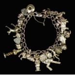 A 9ct gold link charm bracelet with heart pattern padlock clasp, hung with twenty-three charms,