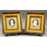 A pair of late 18th Century English white opaque glass profiles of George III and Queen Charlotte,