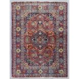 A Tabriz rug woven in colours with a bold central medallion and conforming spandrels, the field