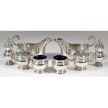 A pair of George VI silver oval sauce boats with cast Celtic pattern rims, high scroll handles