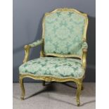 A French gilt frame fauteuil of "Louis XV" design, the shaped and moulded back with scroll and