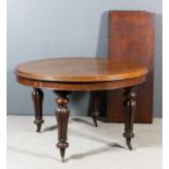 A Victorian mahogany oval extending dining table with two extra leaves, moulded edge to top, on