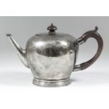 A plain silver bulbous shaped teapot of "18th Century" design, with narrow tapered spout, flat lid