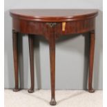 An 18th Century mahogany semi-circular tea table with plain folding top enclosing a well, on