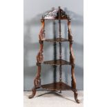 A 19th Century Continental walnut four tier corner whatnot with graduating tiers and with fretted