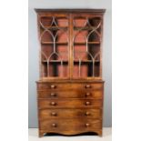 A late George III mahogany secretaire bookcase, the upper part with dentil moulded cornice, fitted