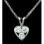 An 18ct white gold mounted diamond heart shaped pendant by Tiffany & Co, set with three brilliant