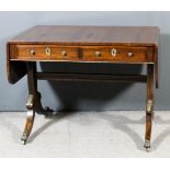 A Regency rosewood and gilt metal mounted rectangular sofa table, the top inlaid with stringings,