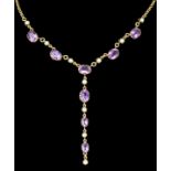 A 9ct gold mounted amethyst and seed pearl necklace, set with eight oval facet cut amethysts (