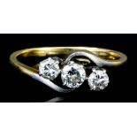 An 18ct gold mounted three stone diamond crossover ring, set with three old cut diamonds (