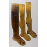 Three stained beechwood stocking lasts, the largest 31.5ins long