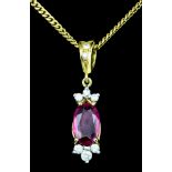 An 18ct gold mounted ruby and diamond pendant, set with an oval ruby (approximately .75ct) and eight