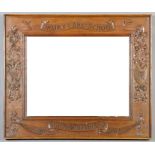 An early 20th Century oak framed rectangular wall mirror, the frame with crisply carved