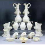A small collection of Belleek porcelain, including - pair of ewers applied with moulded flowers