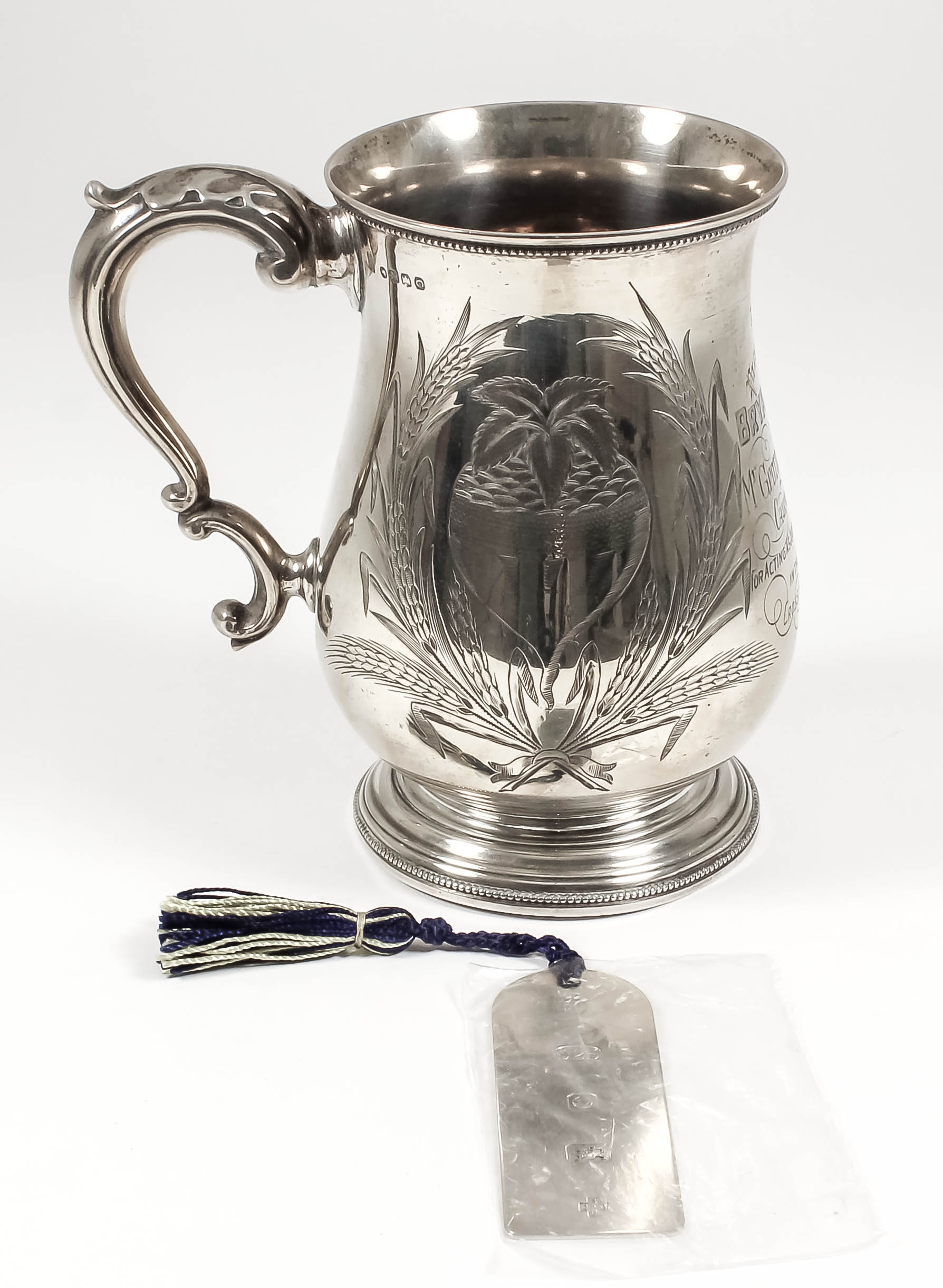 A Victorian silver baluster shaped tankard with bead mounts to rims, engraved with fruit and corn