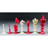 A late 19th Century turned and carved ivory and red stained ivory chess set, Kings 4.25ins high,
