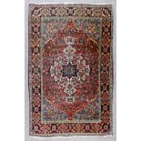 A Bakhtiari rug woven in colours with a bold central shaped medallion and shaped spandrels, the