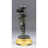 A good 19th Century French dark green patinated bronze figure of putti with pan pipes, the ormolu