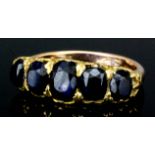 A 9ct gold mounted five stone sapphire ring, set with oval stones of graduating sizes (total