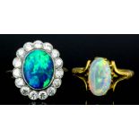 An 18ct white gold and platinum mounted opal and white sapphire cluster ring, set with central