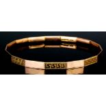 A 9ct rose gold stiff bangle with alternating engraved panels (weight 17 grammes)