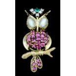An 18ct gold mounted and gem set owl pattern brooch, set with cabochon tourmaline eyes (