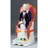 A 19th Century Staffordshire pottery figure - The Duke of Wellington, seated, with painted and