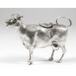A 20th Century silvery metal cow creamer, 4.25ins high (weight 9.3ozs)