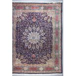 A Tabriz carpet woven in colours, the central medallion surrounded by bold ovoid palmettes and